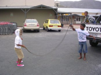 Kids play in the parking lot while the parents do some shopping